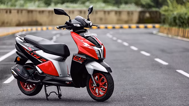 Sleek black electric scooter with LED display parked on modern city sidewalk
